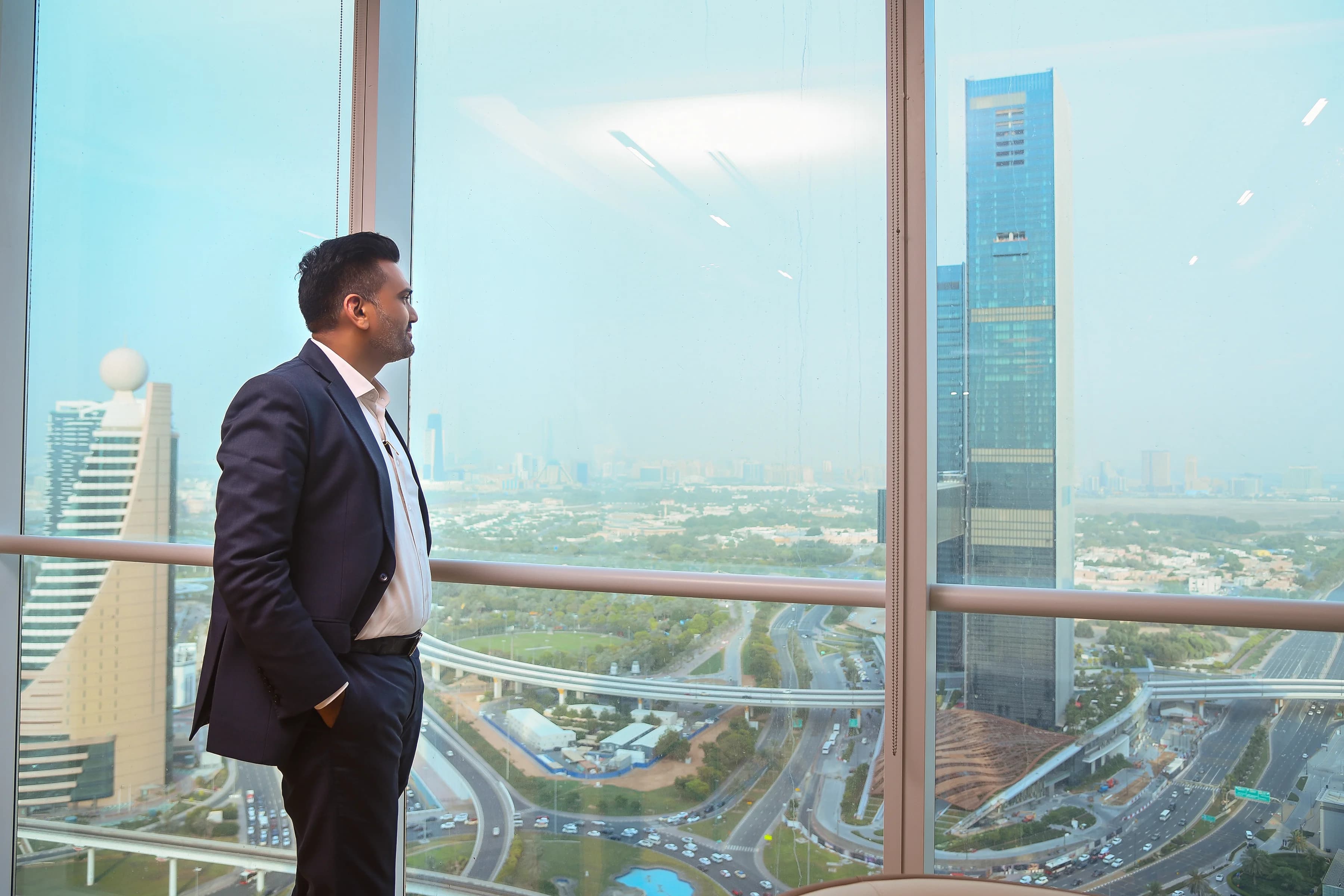 Jashvantkumar Prajapati overlooking the Dubai skyline from Avyanco office